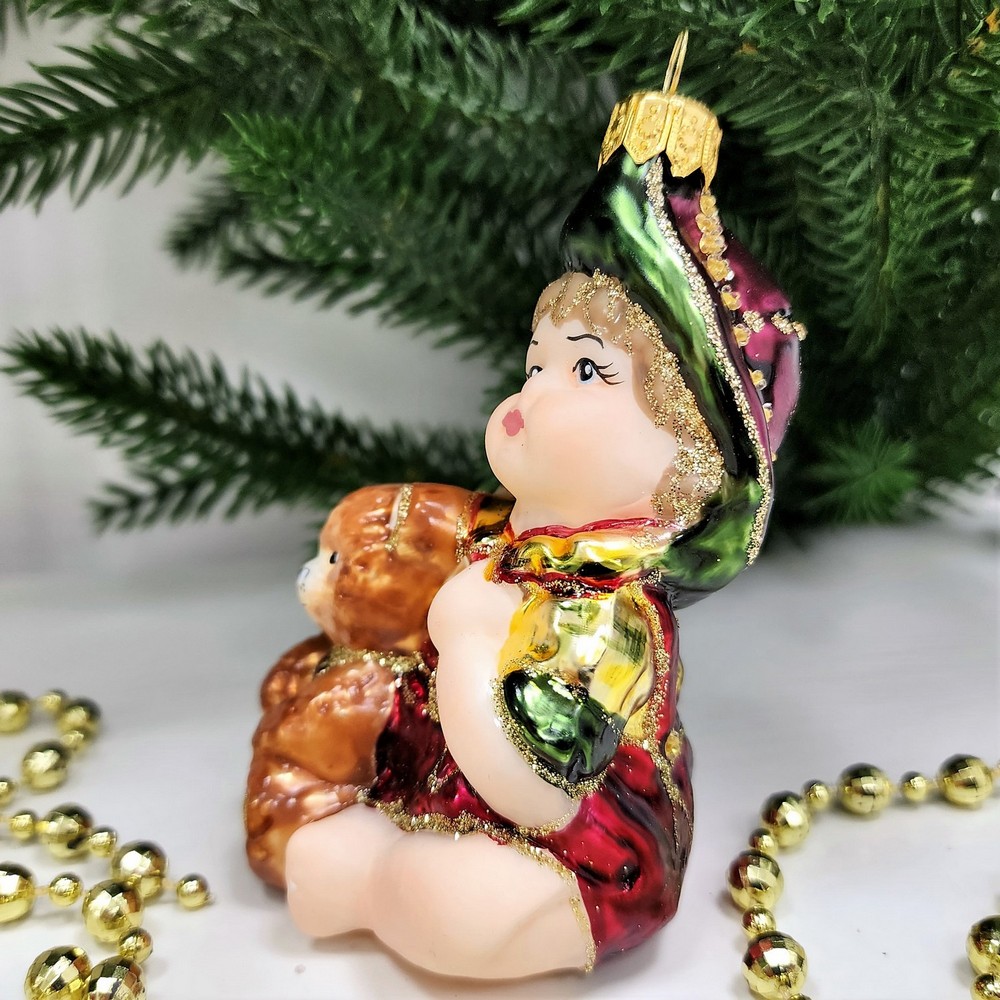 фото Стеклянная елочная игрушка Девочка с мишкой сидит