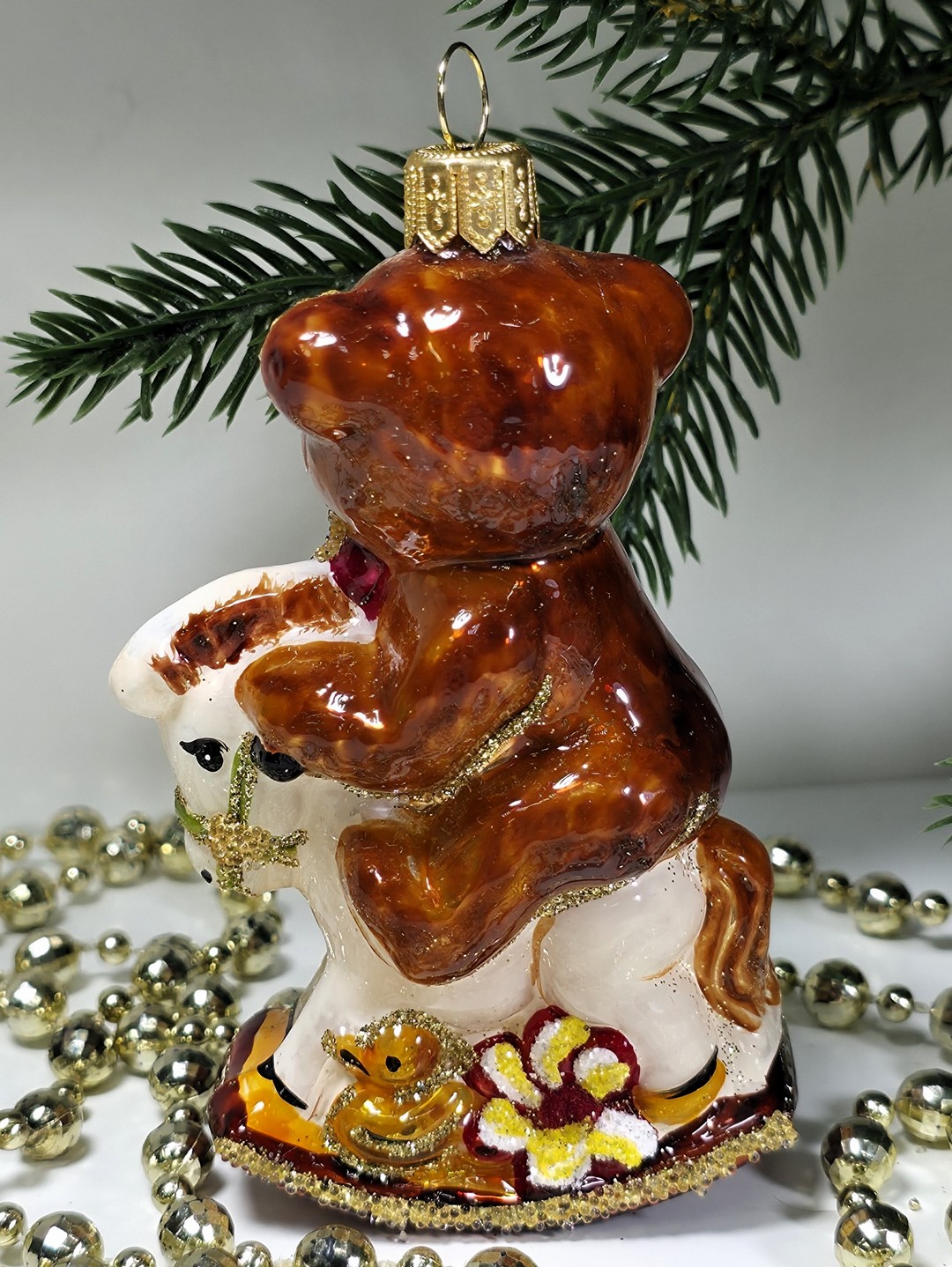 фото Стеклянная елочная игрушка Мишка на лошадке качалке