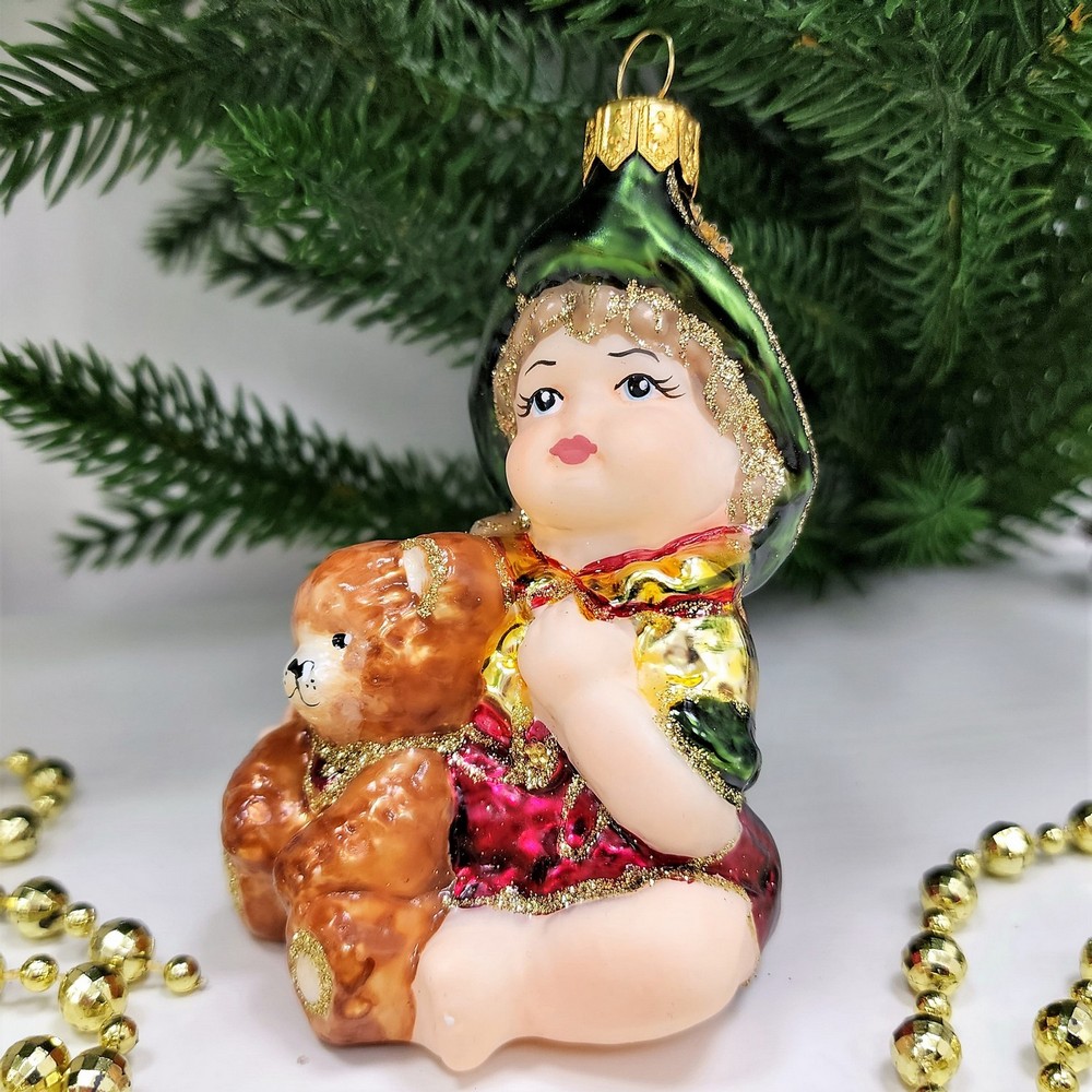 фото Стеклянная елочная игрушка Девочка с мишкой сидит