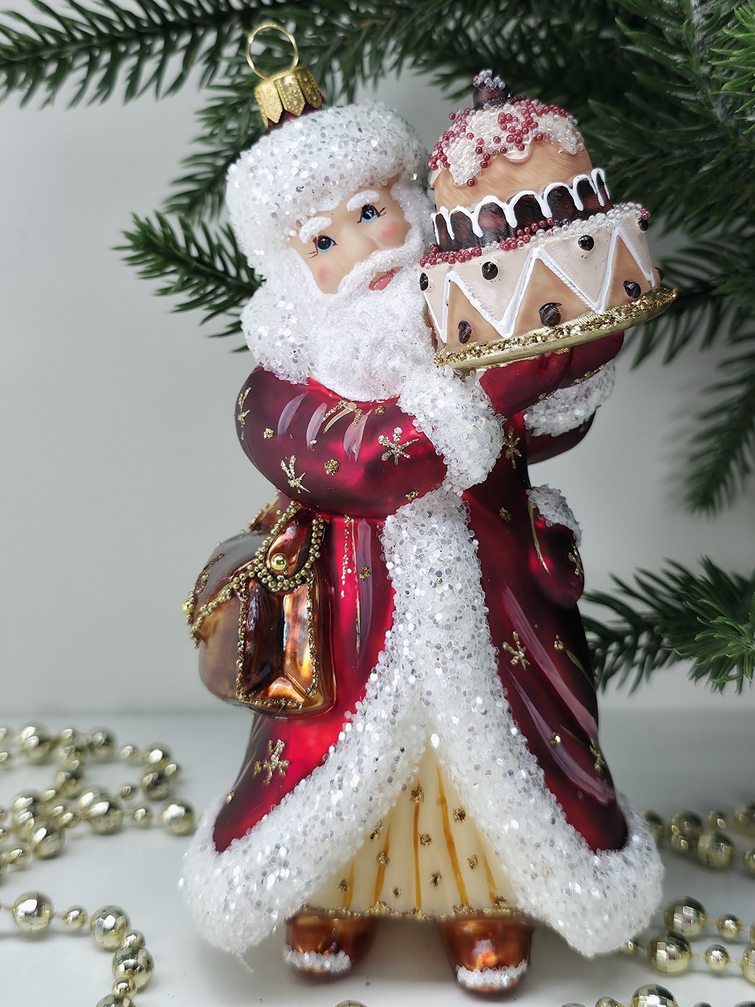 фото Стеклянная елочная игрушка Дед Мороз с тортом