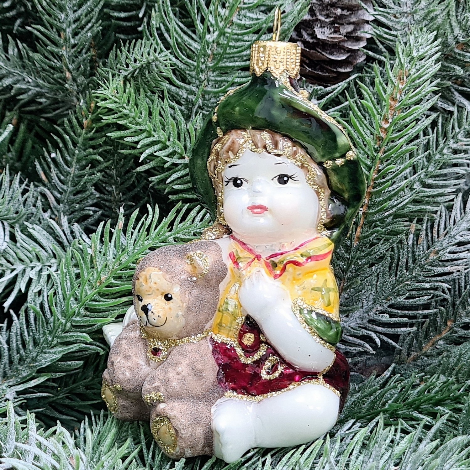 фото Стеклянная елочная игрушка Девочка с мишкой сидит